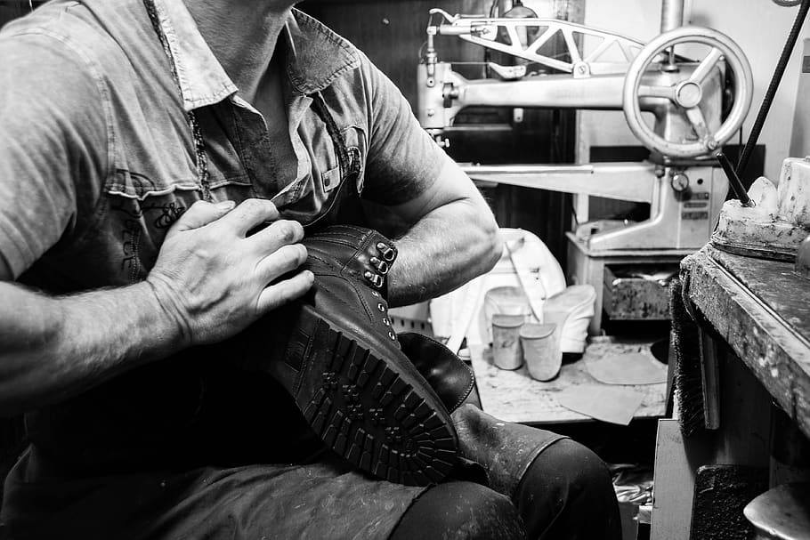 A cobbler working on a boot, from the original Heel Sew Quik website